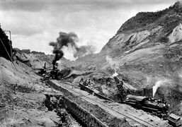 Trains hauling dredged soil from the canal